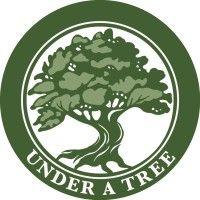 under a tree logo image