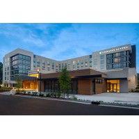 embassy suites by hilton alpharetta halcyon logo image