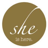 she is here logo image