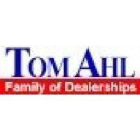 tom ahl family of dealerships logo image